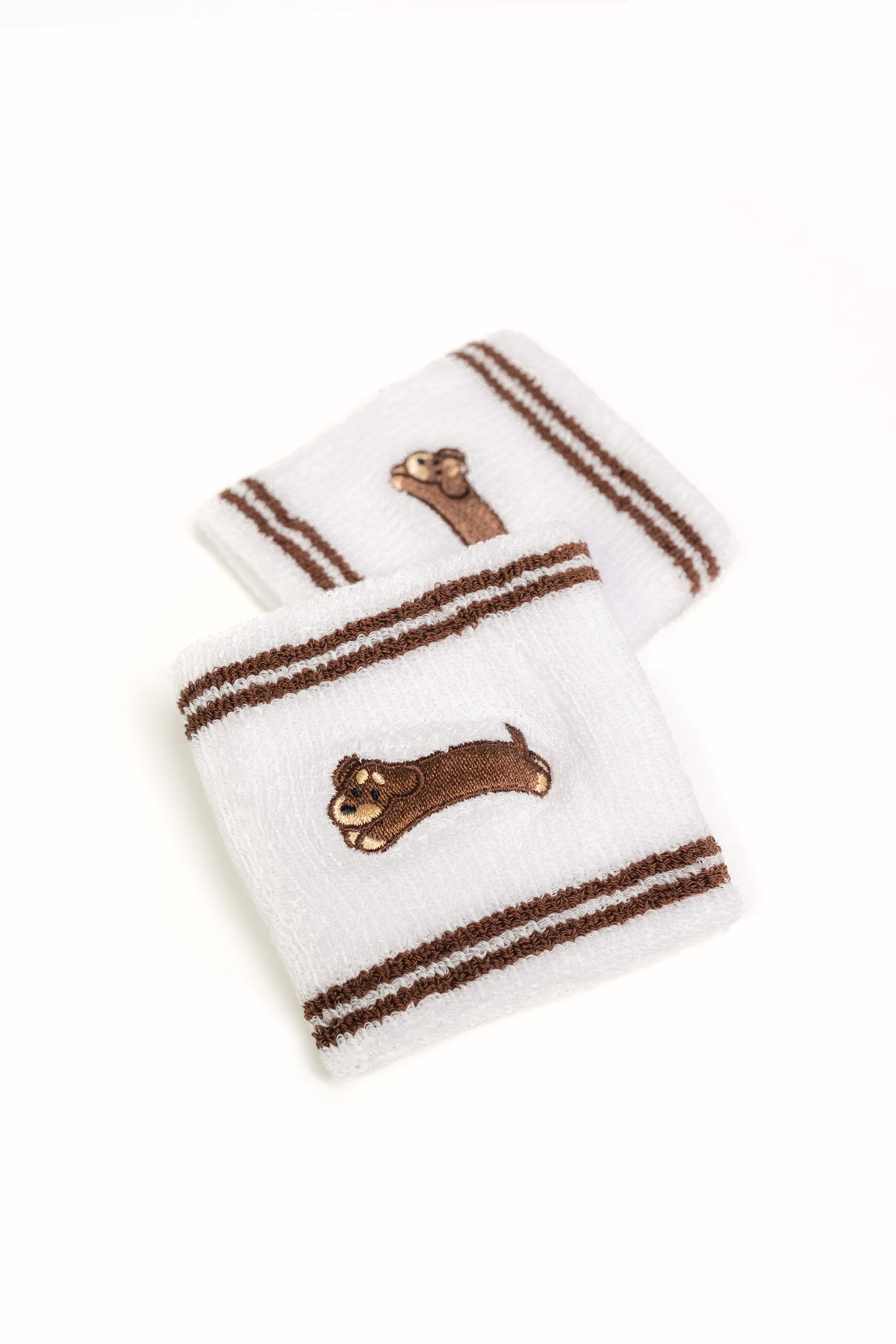 Close-up detail of terry embroidery and cotton fabric on dachshund dog wristband