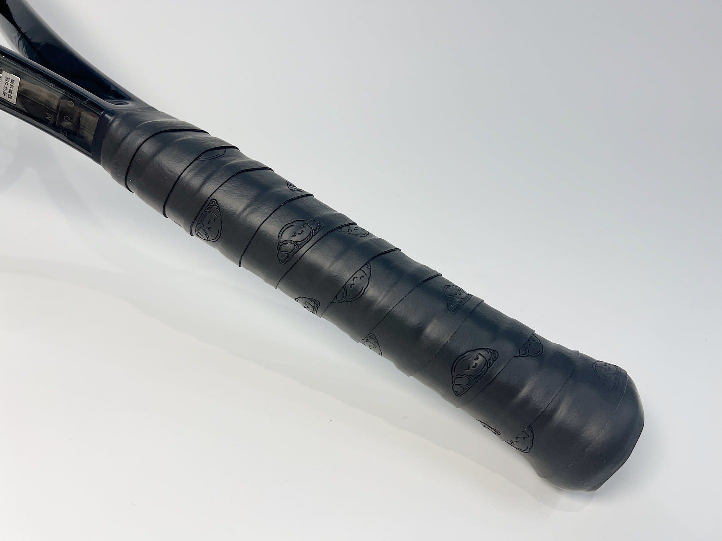 Black Croissant Tennis Overgrip Wrapped on Tennis Racket Handle