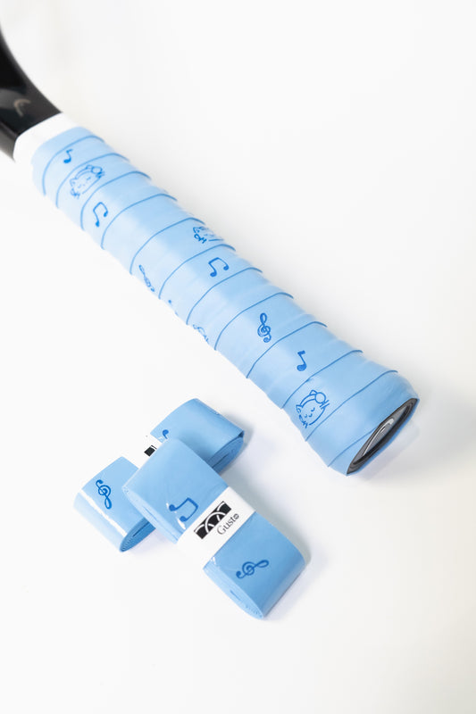 Blue tennis racket overgrip with cat and music note design, wrapped on racket handle.