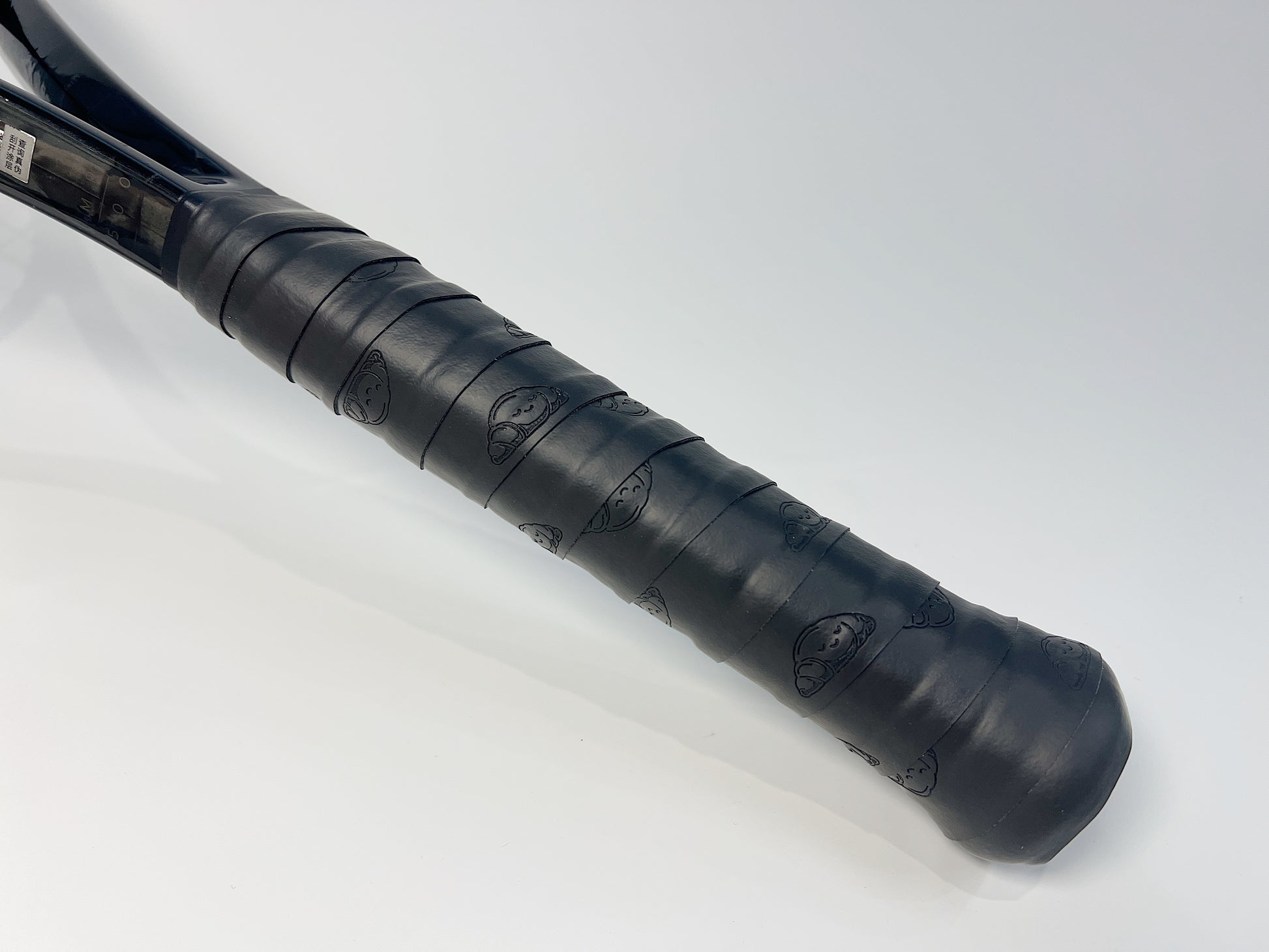 Black Croissant Tennis Overgrip Wrapped on Tennis Racket Handle