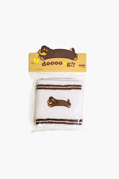 White cotton terry wristband with dachshund dog embroidery, single piece close-up